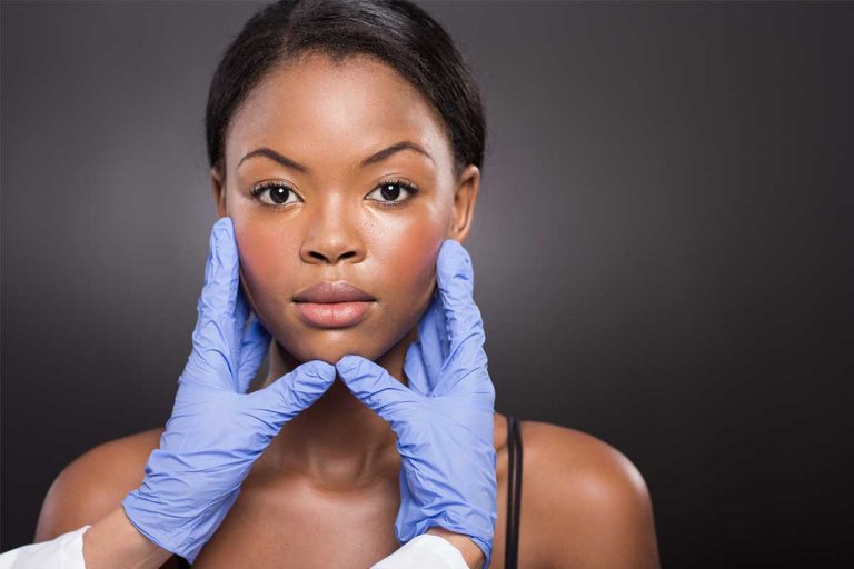 Plastic surgeon checking woman face in Palm Beach area